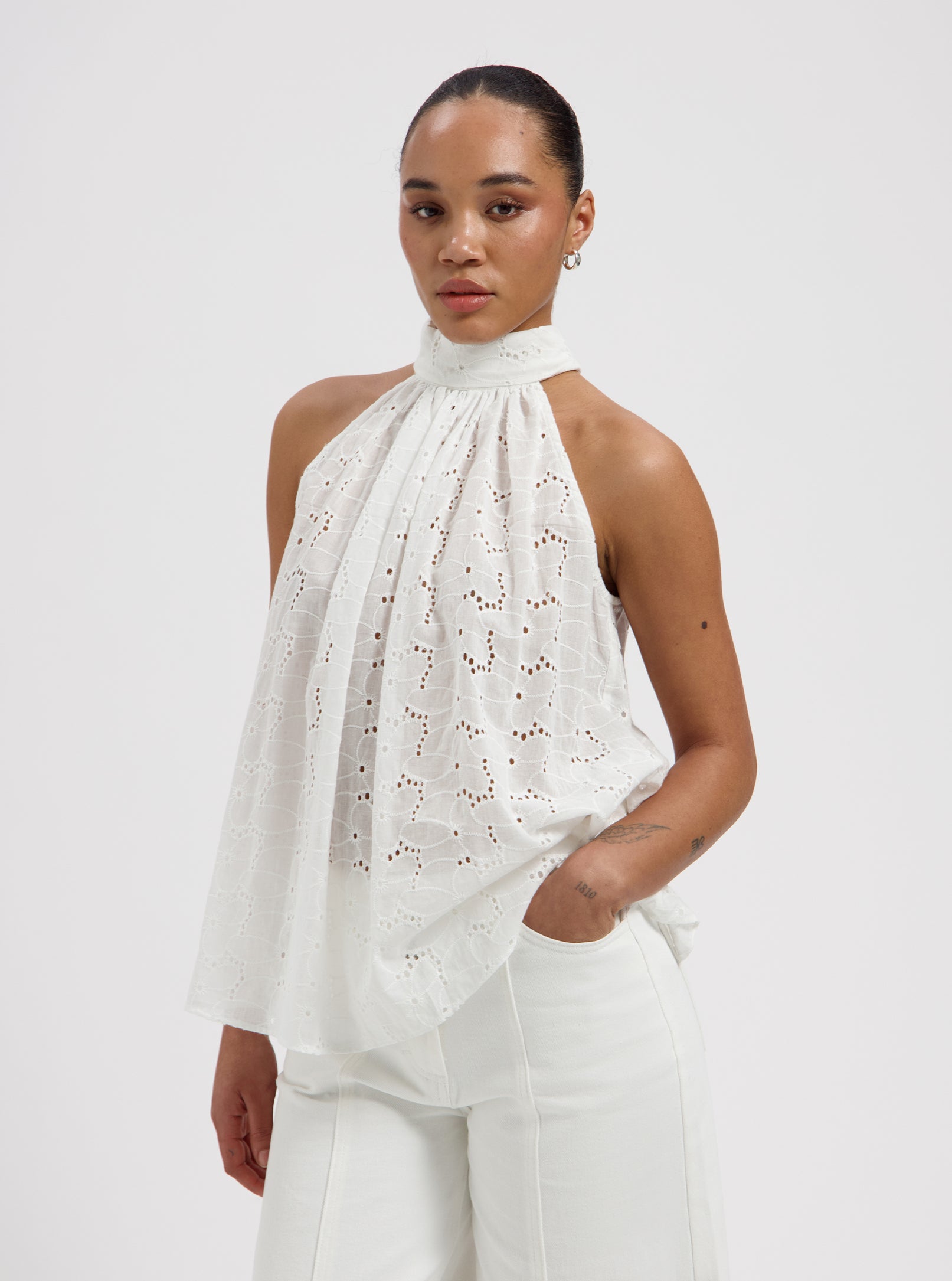 White broderie anglaise halter top with high neck and flowy silhouette by Nous Sommes Labels
