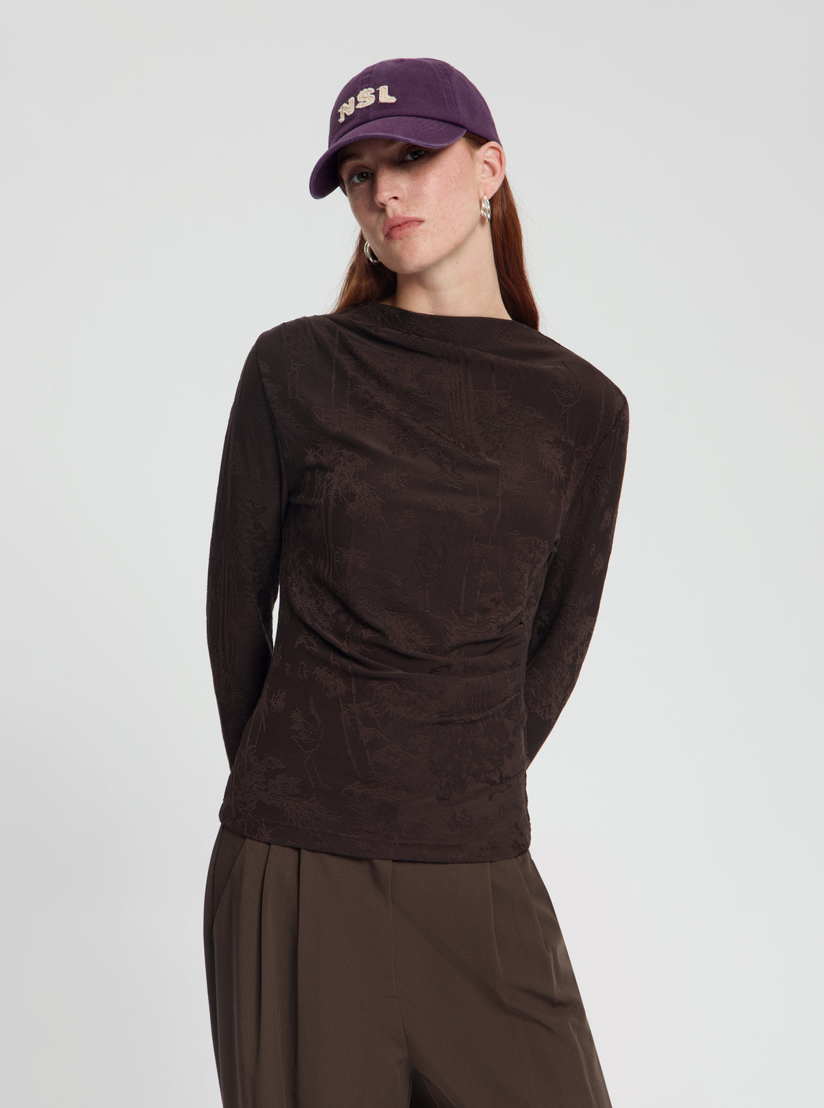 Model wearing Baseball Cap with NSL logo - NOUS SOMMES LOGO 