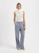 White sleeveless draped top with high neckline by Nous Sommes Labels 