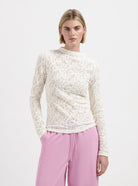 Cream textured long sleeve top with high neckline by Nous Sommes Labels 