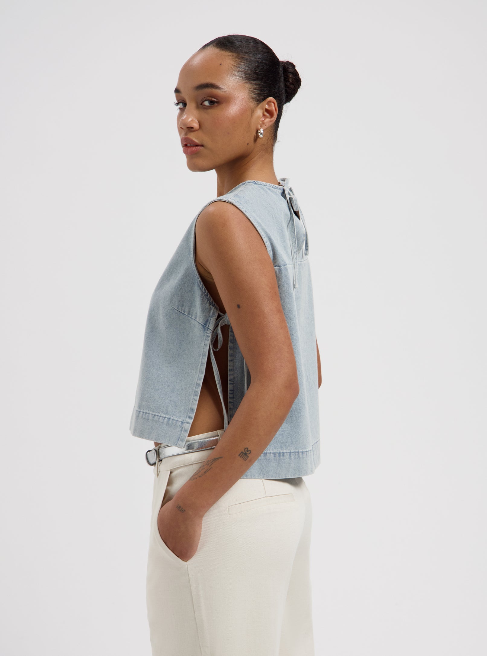 Light blue sleeveless floral print top with side tie details and relaxed fit by Nous Sommes Labels 