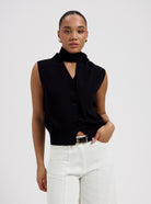 Black sleeveless knit top with a tie neckline by Nous Sommes Labels 