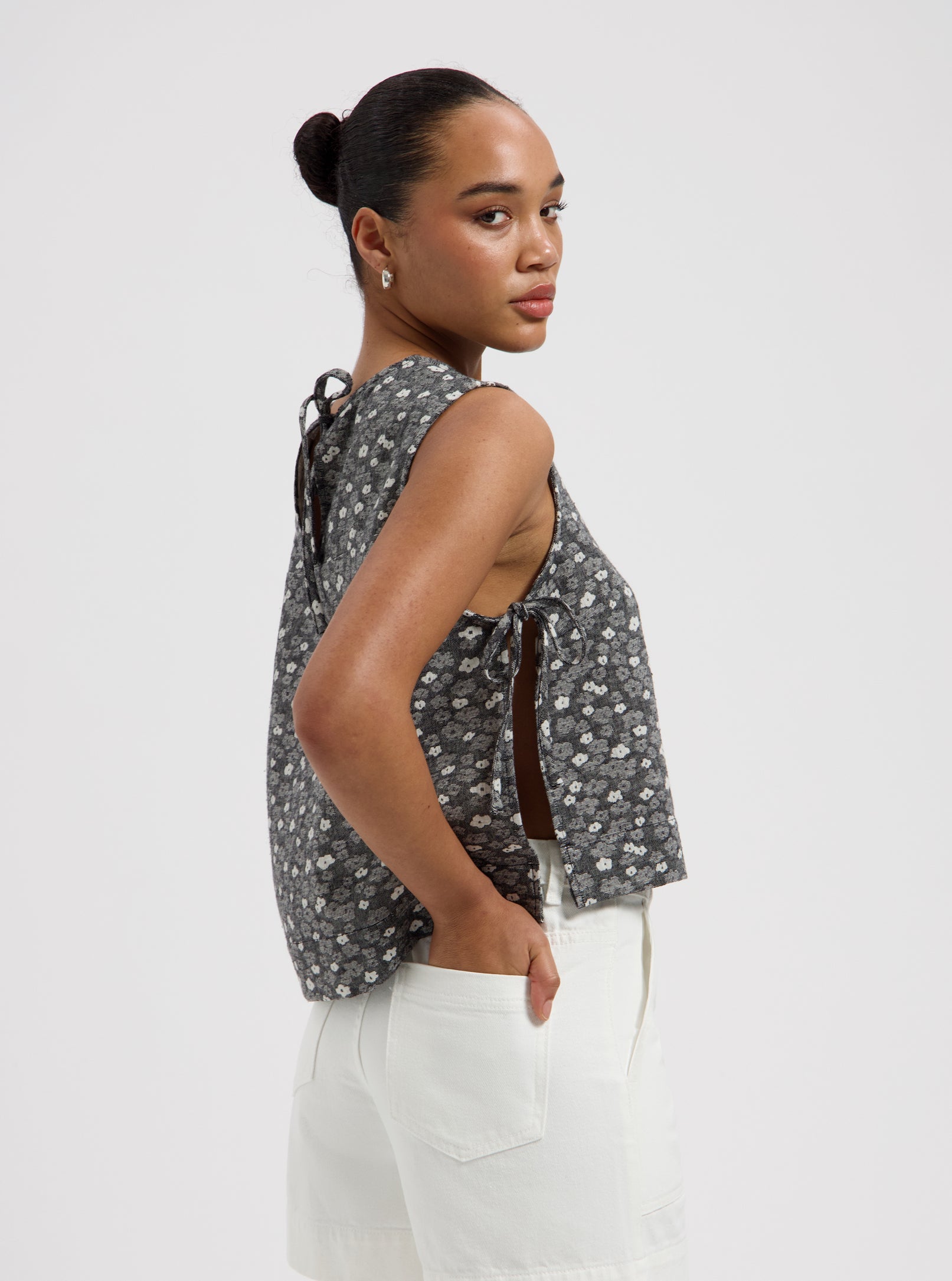 Grey sleeveless floral print top with side tie details and relaxed fit Nous Sommes Labels