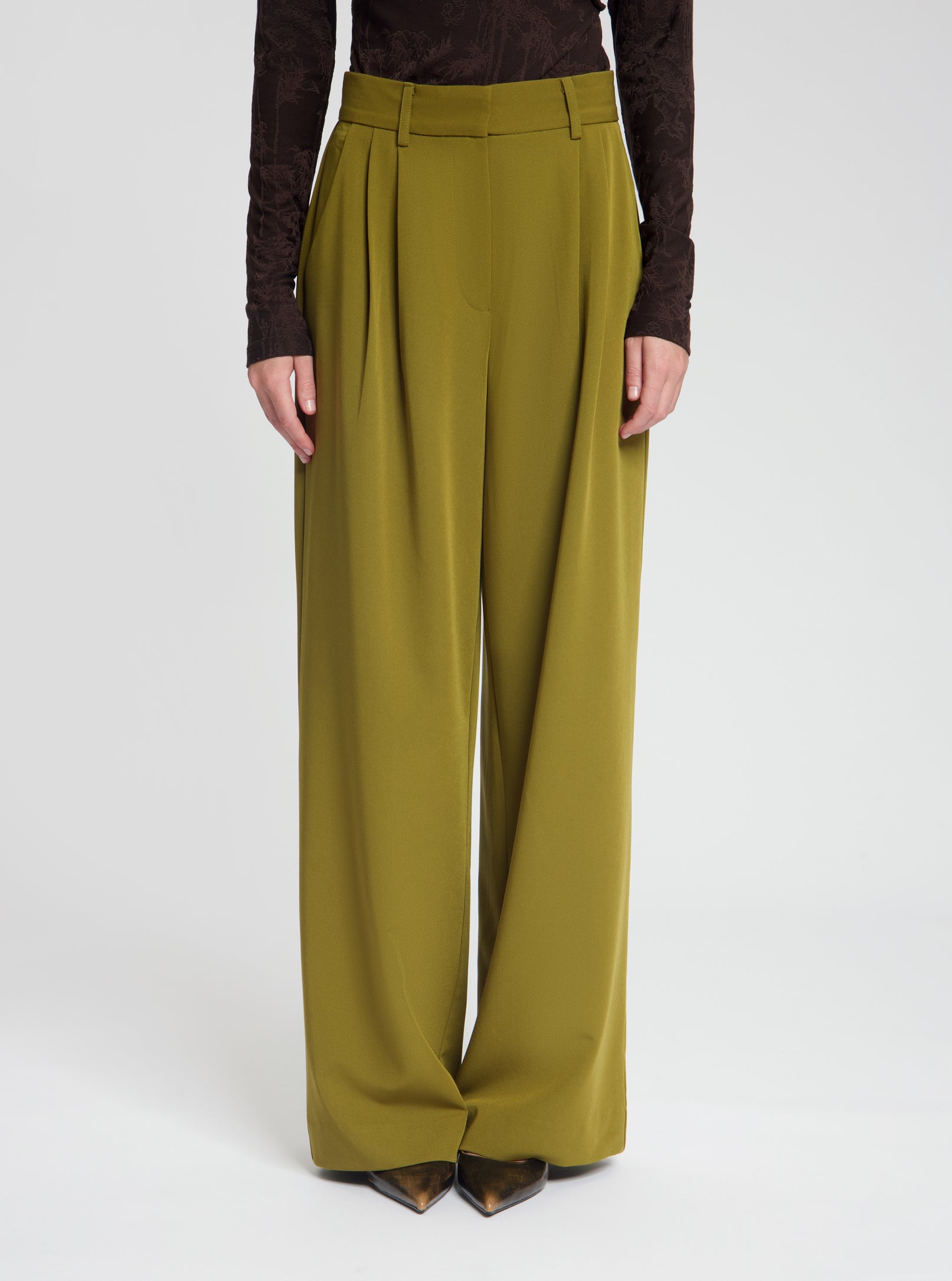 Model wearing Gabbie trousers in dark olive - NOUS SOMMES LABELS 