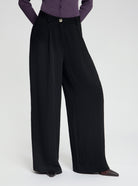 Model wearing high-waisted, wide-leg black Wren trousers - NOUS SOMMES LABELS