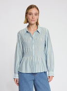 Model wearing the Anna Blouse in Light Blue Stripe - NOUS SOMMES LABELS